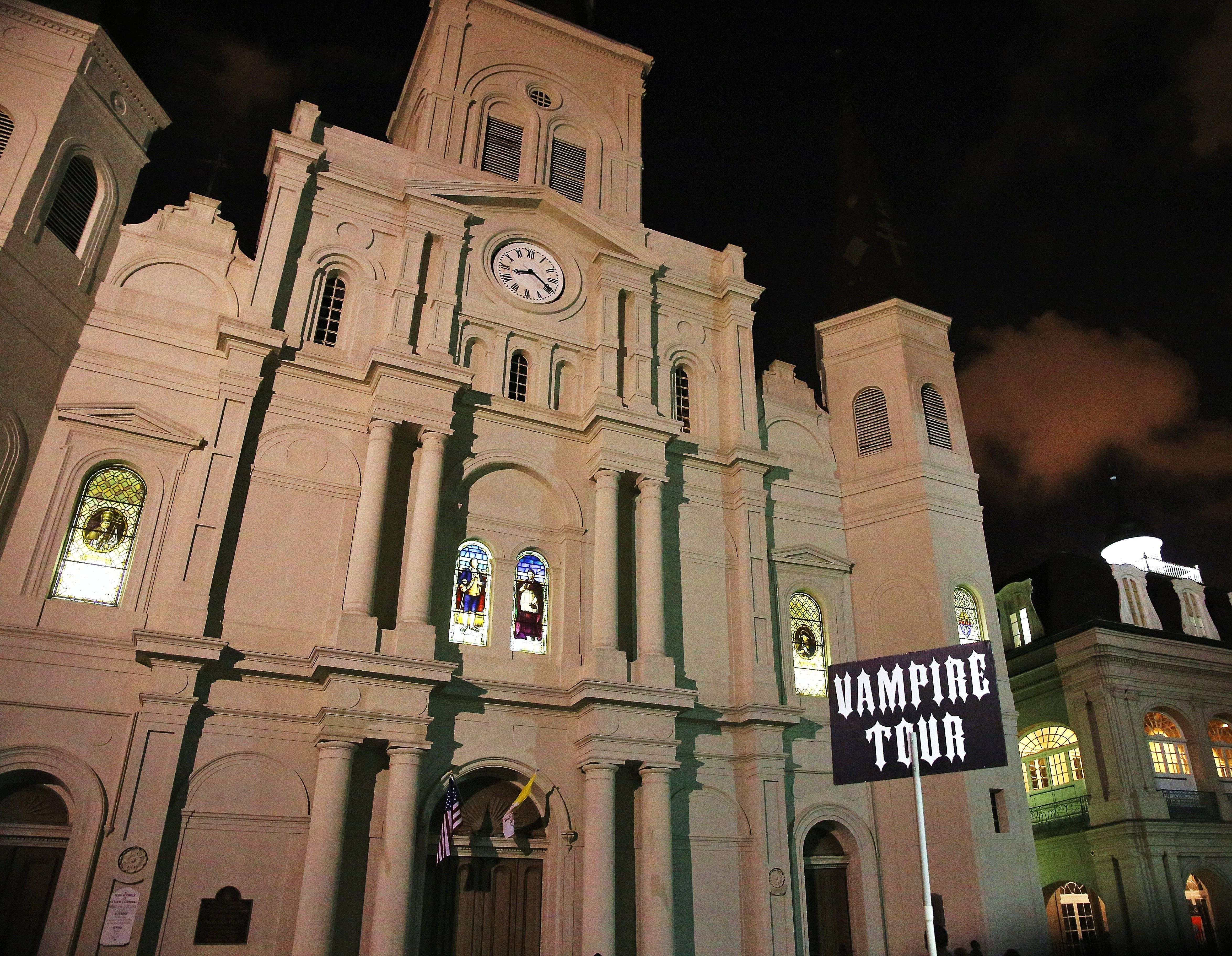 St. Louis Cathedral at night with Vampire Tour sign in foreground