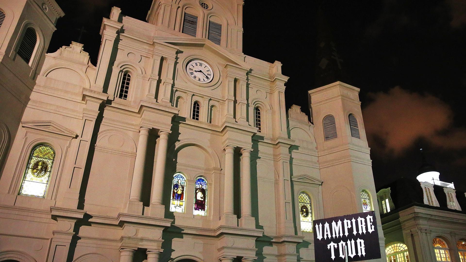 St. Louis Cathedral at night with Vampire Tour sign in foreground