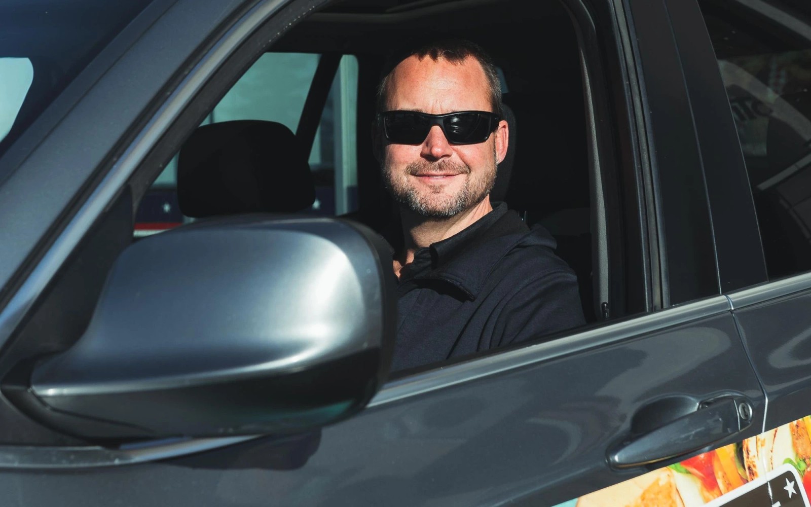 A Wrapped driver smiling in the driver’s seat