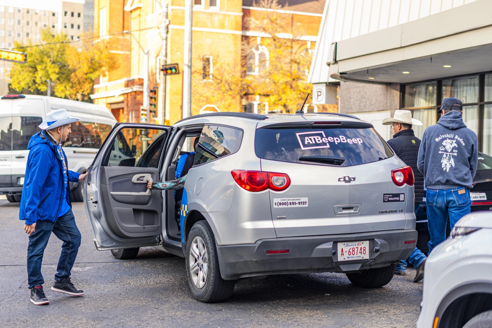 ATB free-rides ambassador welcoming a rider into a branded vehicle