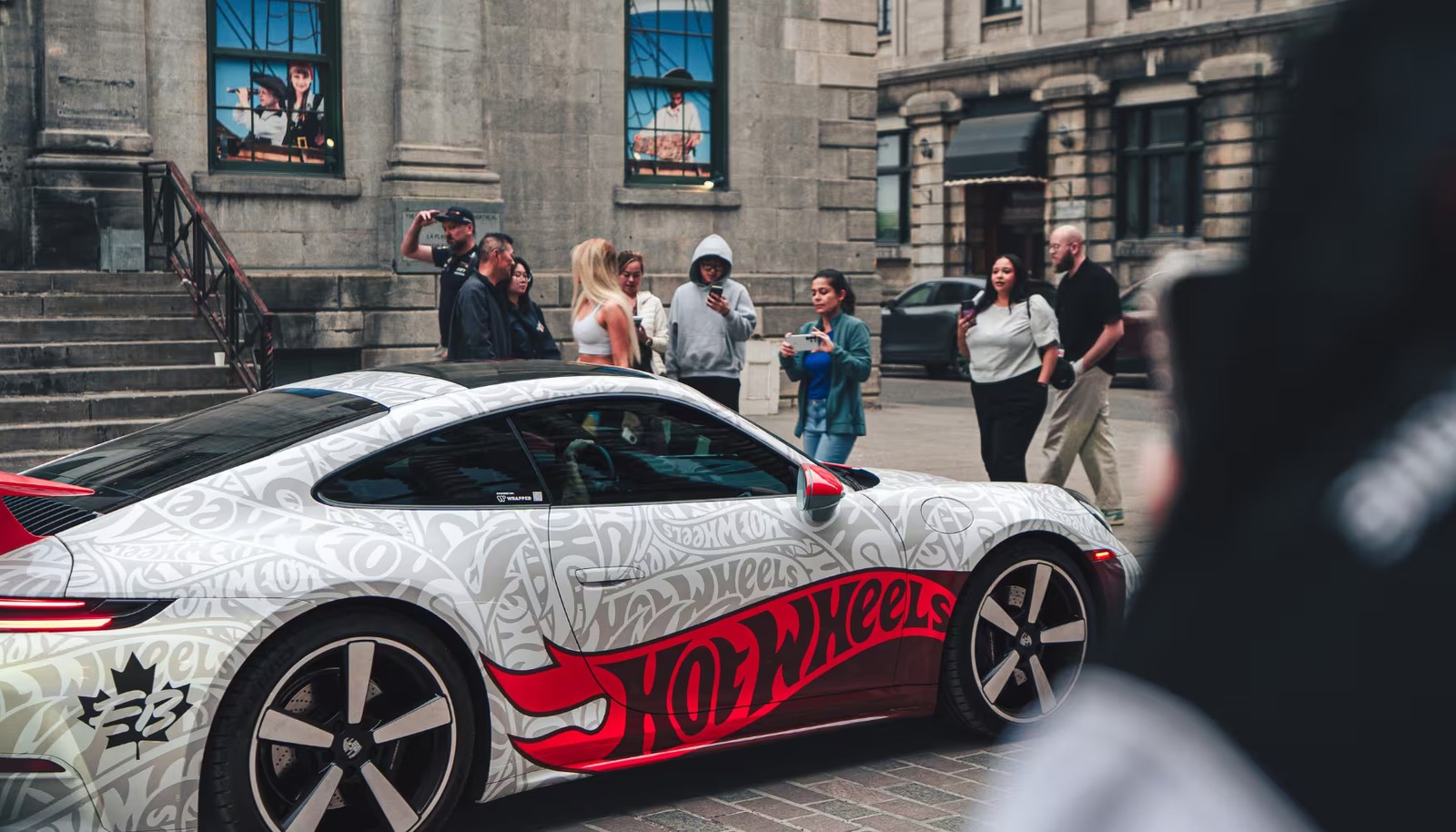 A white Hot Wheels-wrapped Porsche on a Montreal street during F1 weekend