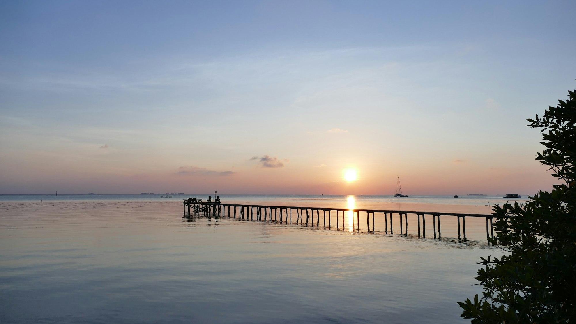 Dermaga kayu Karimunjawa saat matahari terbenam