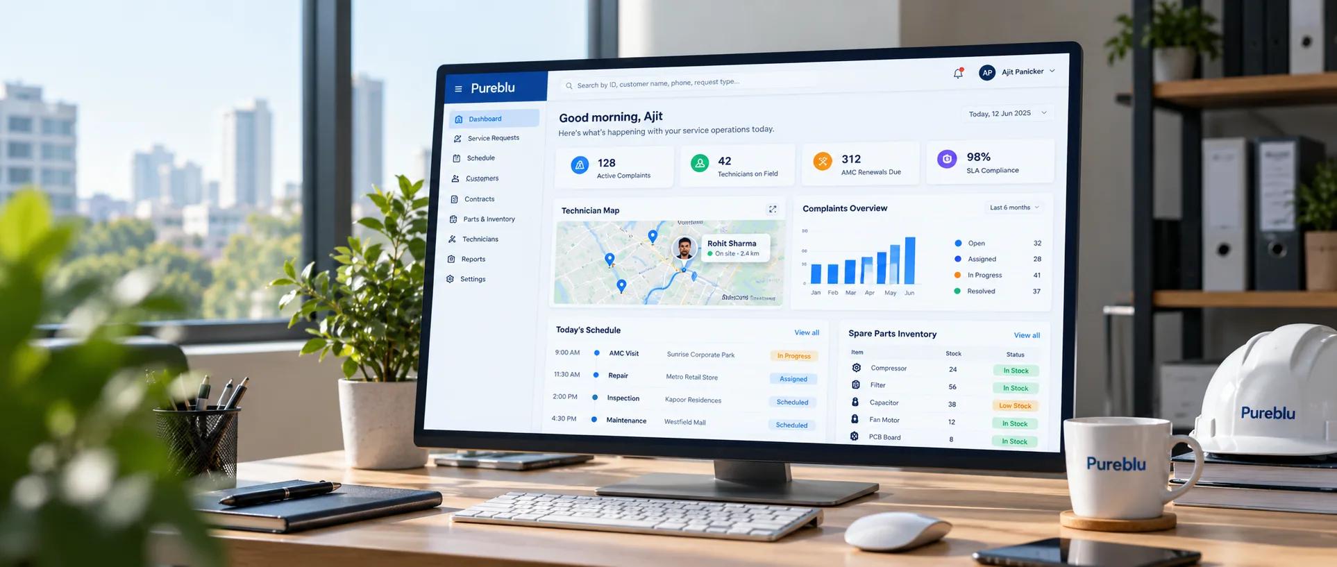 Service operations dashboard on a desktop monitor with technician map, schedule, complaints, and spare-parts panels
