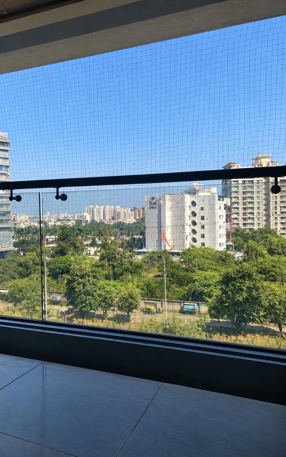 Standing desk beside a window with a city view