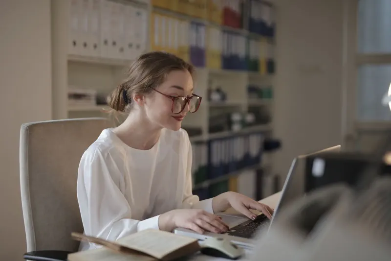 Person wearing glasses while working at a desktop computer