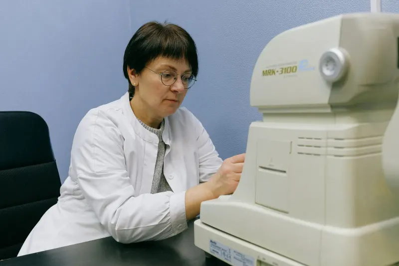 Patient positioned at an eye imaging device during an examination