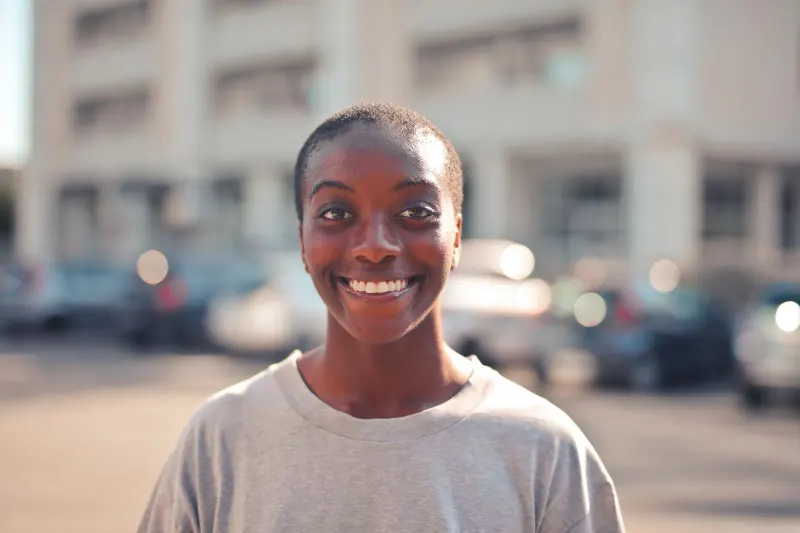 Happy woman smiling outdoors with a soft-focus background