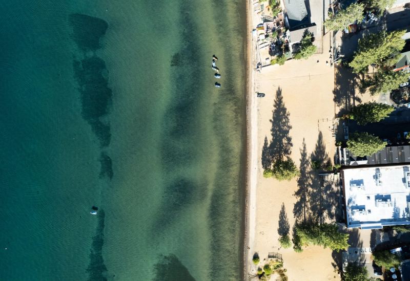 Aerial view of clear turquoise water along the Lake Tahoe shoreline