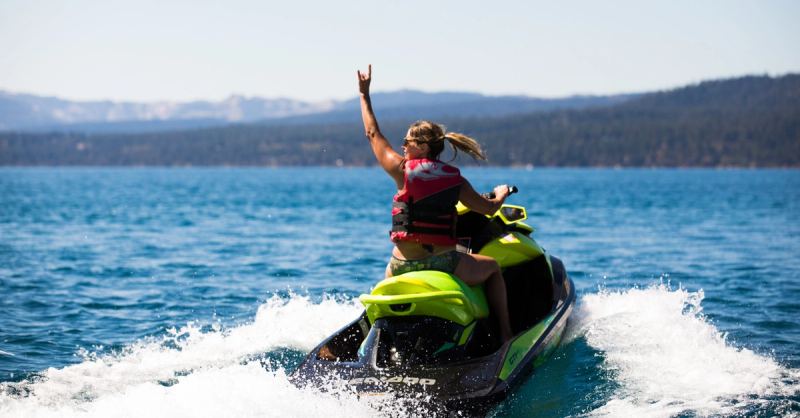 A rider waving from a jet ski on Lake Tahoe