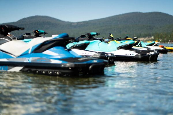 A row of rental jet skis waiting on the water