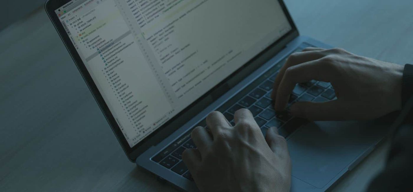 MFA fatigue attack prevention: Tired individual overlooking important security notifications on a laptop screen, showcasing MFA fatigue