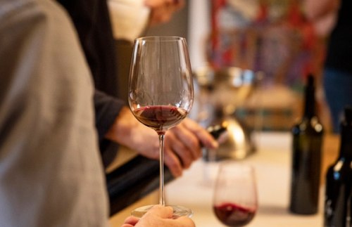hand holding a glass of red wine