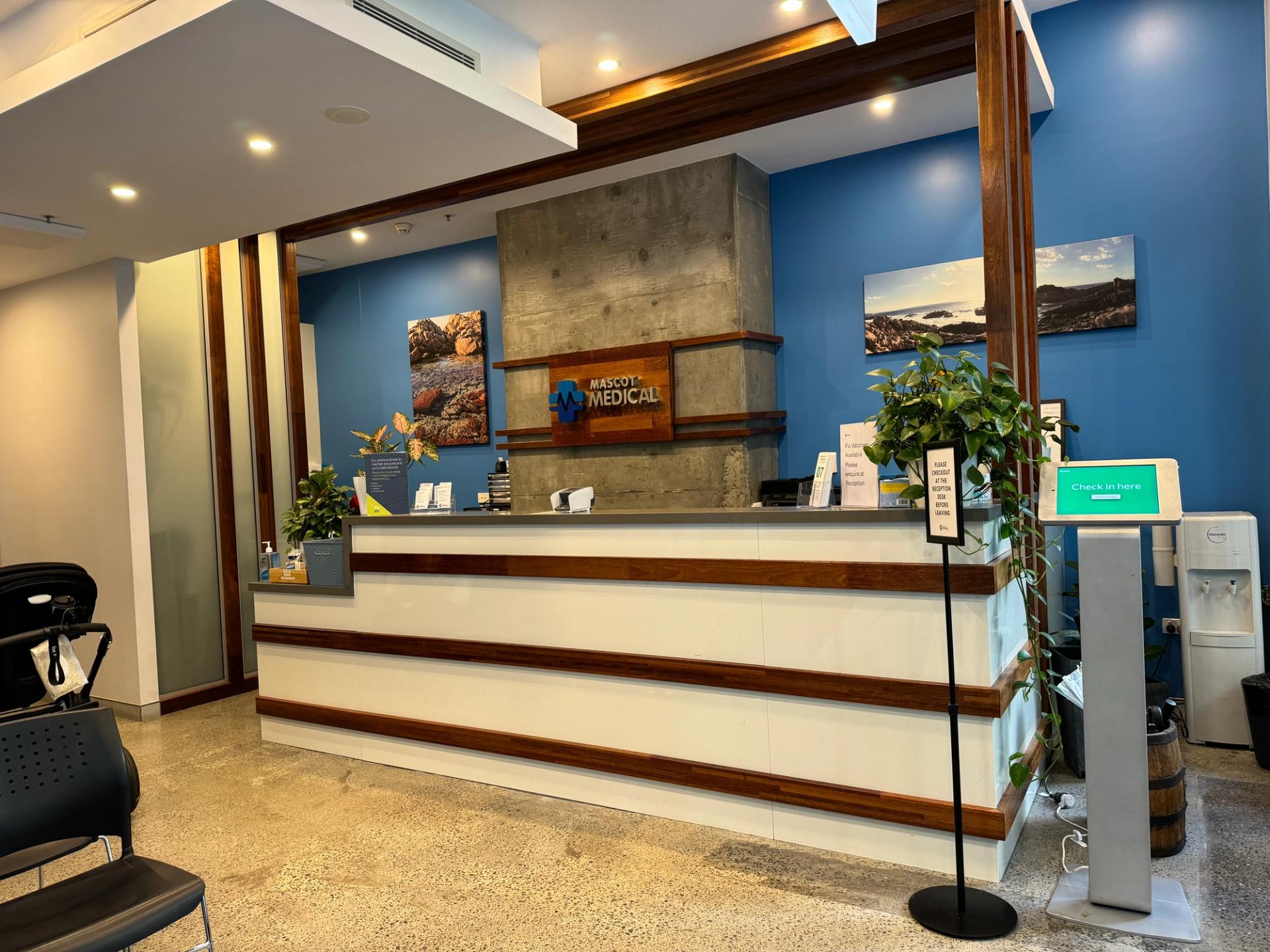 a hospital lobby with a reception desk and chairs .