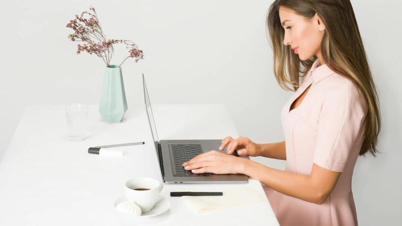 woman sitting while using laptop
