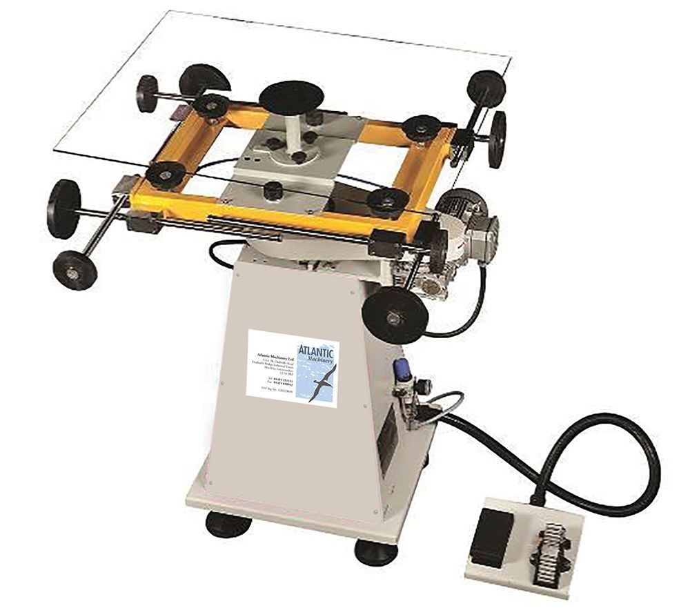 Atlantic rotary sealing table with vacuum cups and foot-operated controls for secondary sealing of insulated glass units.