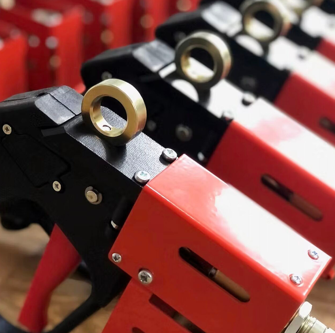 Advance Systems hot melt applicator guns featuring ergonomic handles and precision-engineered components for insulated glass manufacturing.