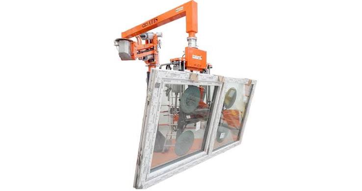 ATIS window frame handling manipulator lifting and positioning a complete window frame during manufacturing.