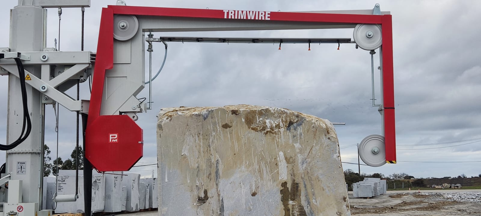 Pellegrini Trimwire mobile tracked diamond wire saw cutting natural stone blocks in a quarry