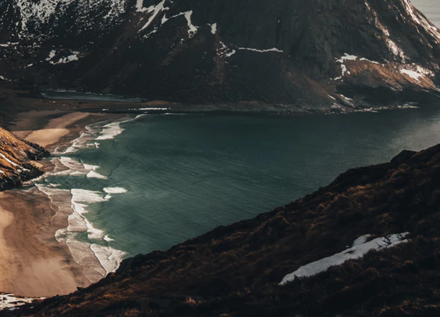 Mountains in cloudly weather with a beach.