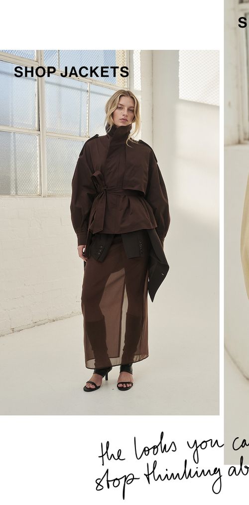 Model posing in a brown cropped trench jacket. SHOP JACKETS.