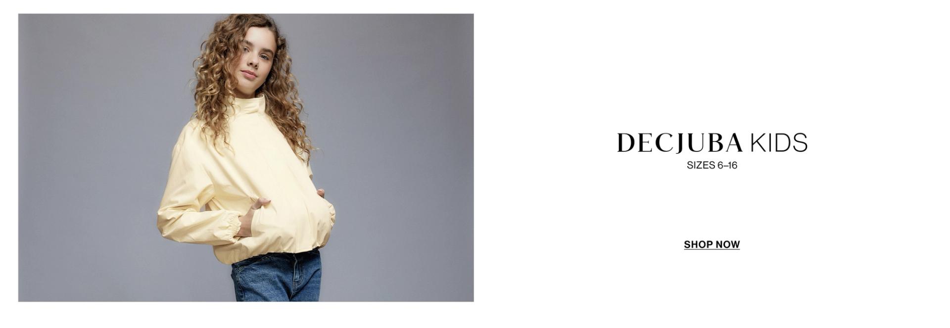 A young girl posing in a yellow jacket with text overlay: "DECJUBA KIDS"