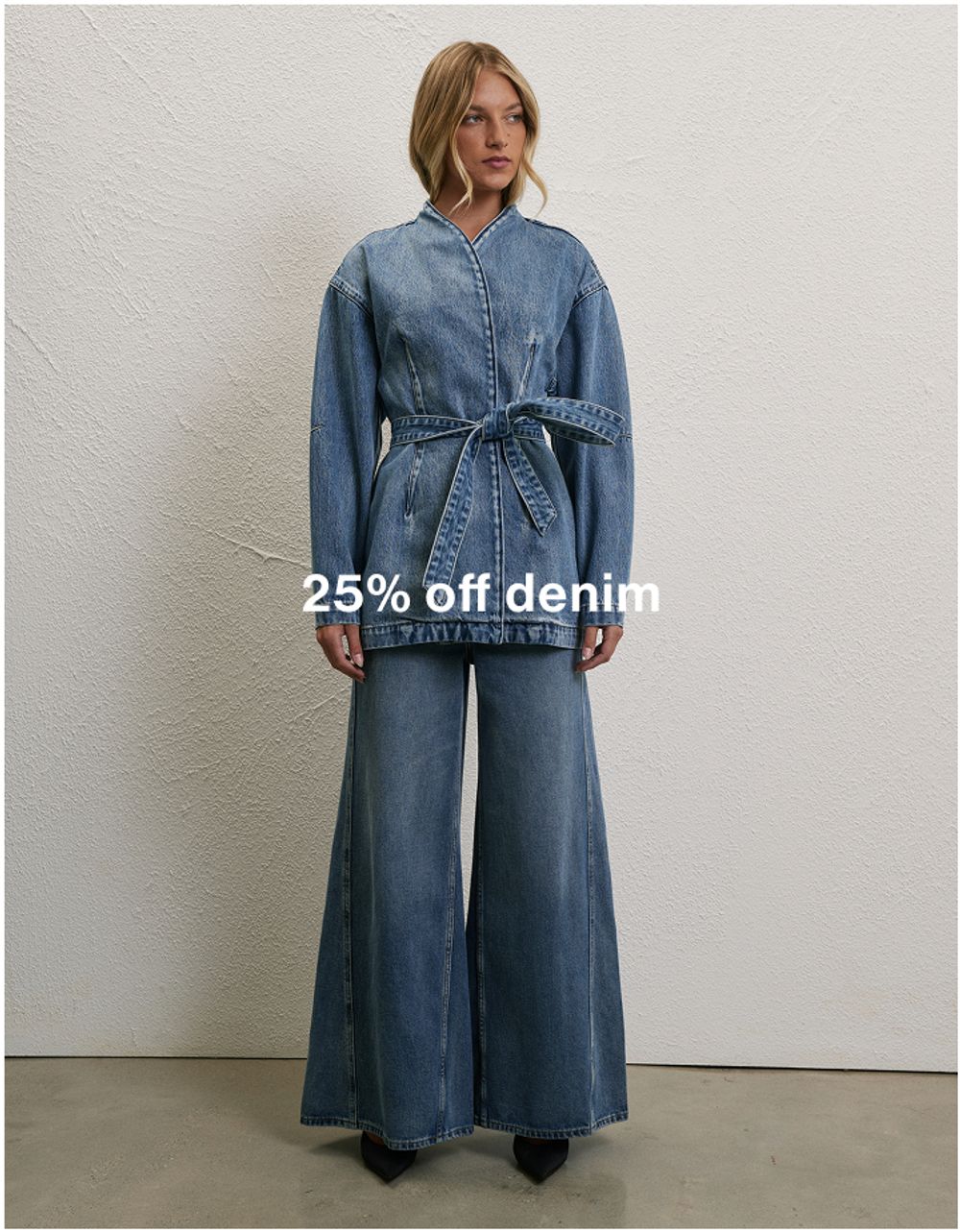 Model wearing a light denim jacket and jeans, promoting 25% off denim.