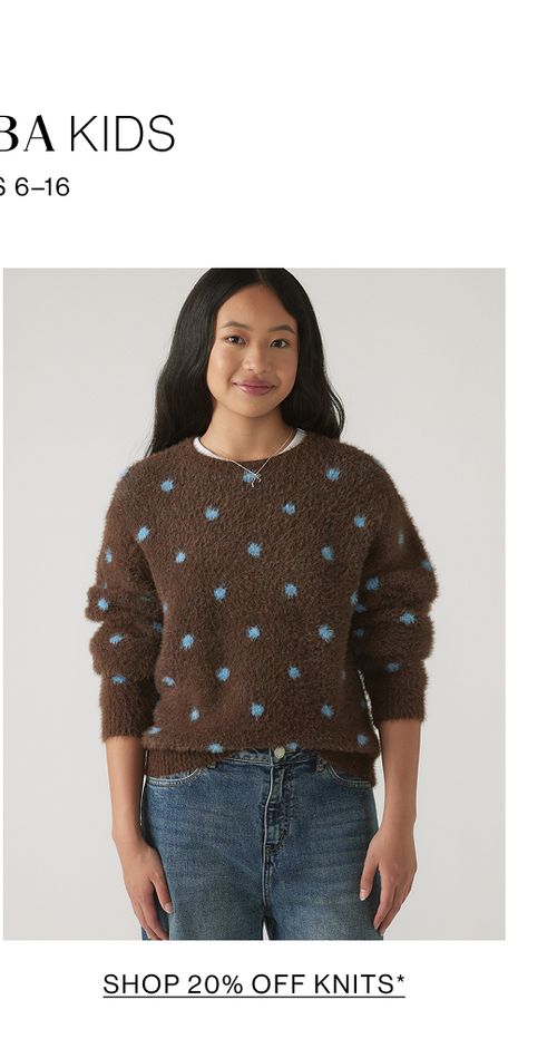 Young model wearing a brown knit with blue polka dots. SHOP 20% OFF TEEN GIRLS KNITWEAR.