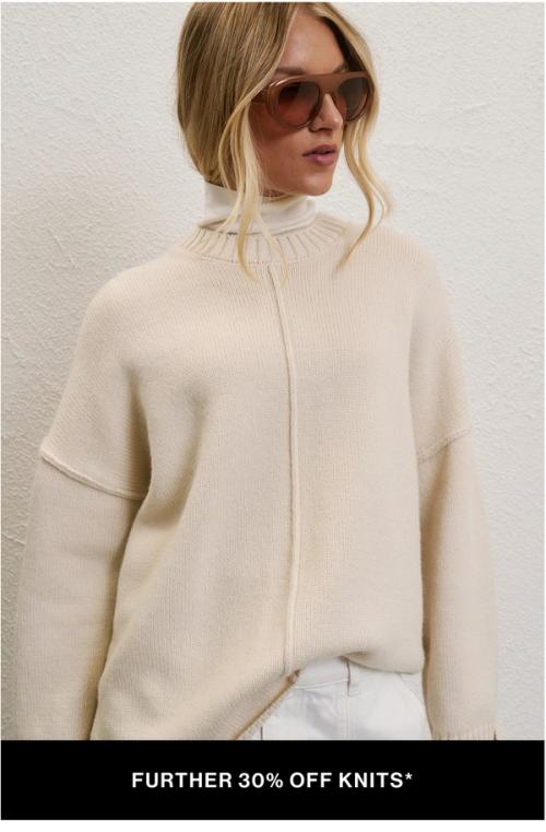 A model wearing a cream knit against a neutral background. SHOP FURTHER 30% OFF SALE KNITS.