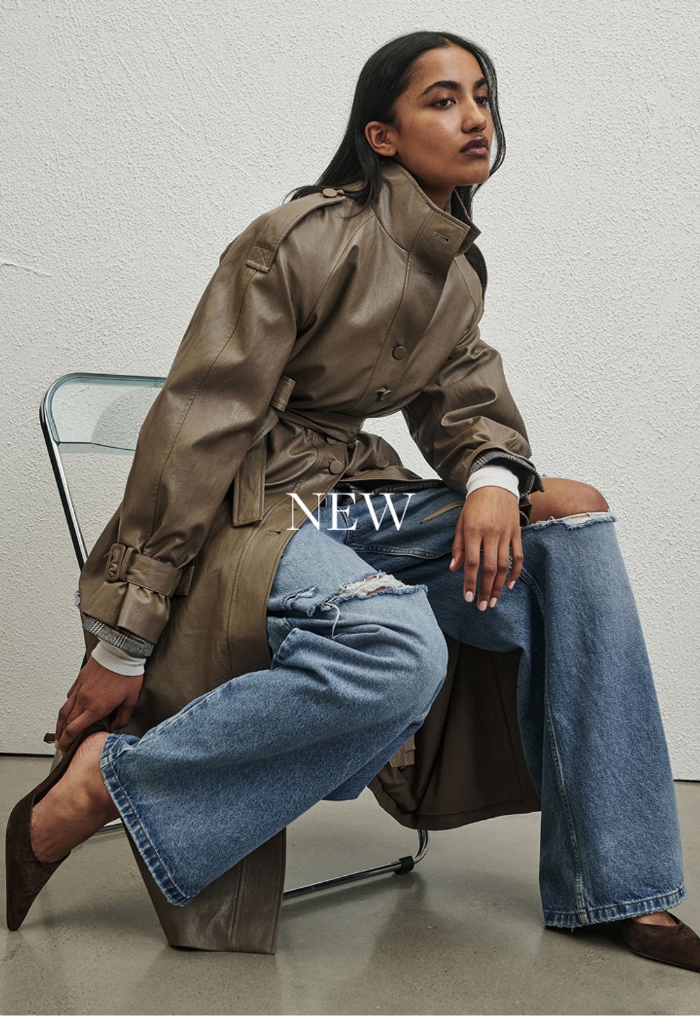 Model wearing a khaki trench. SHOP NEW.