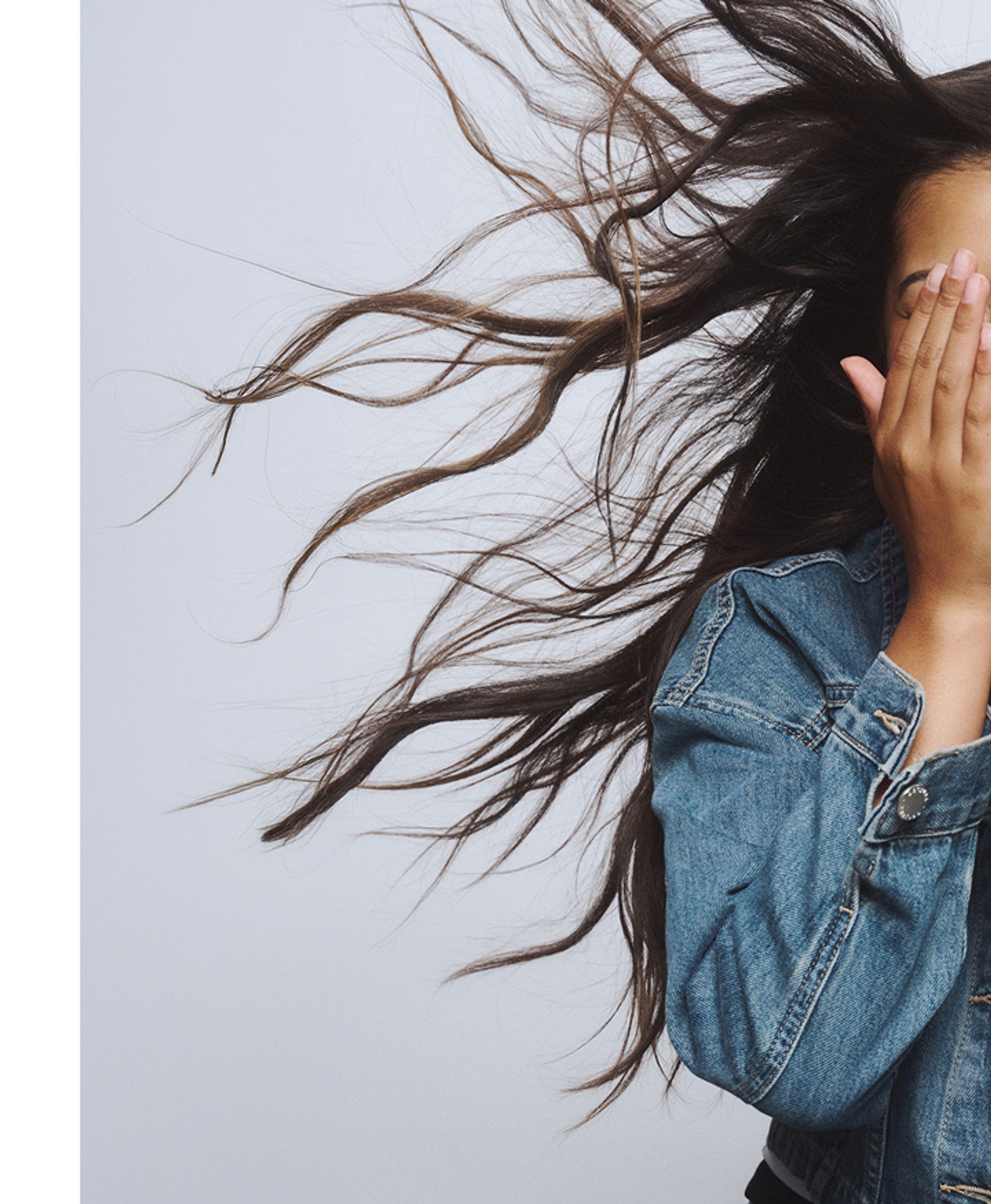 A young girl with her hands on her face
