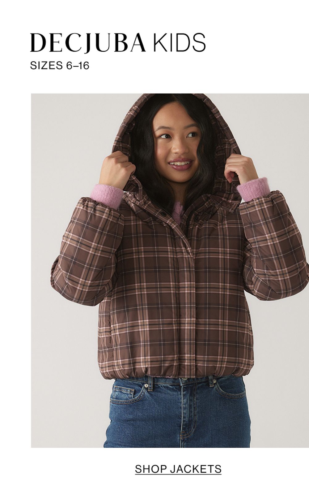 Child wearing a brown checkered jacket with text that states DECJUBA KIDS