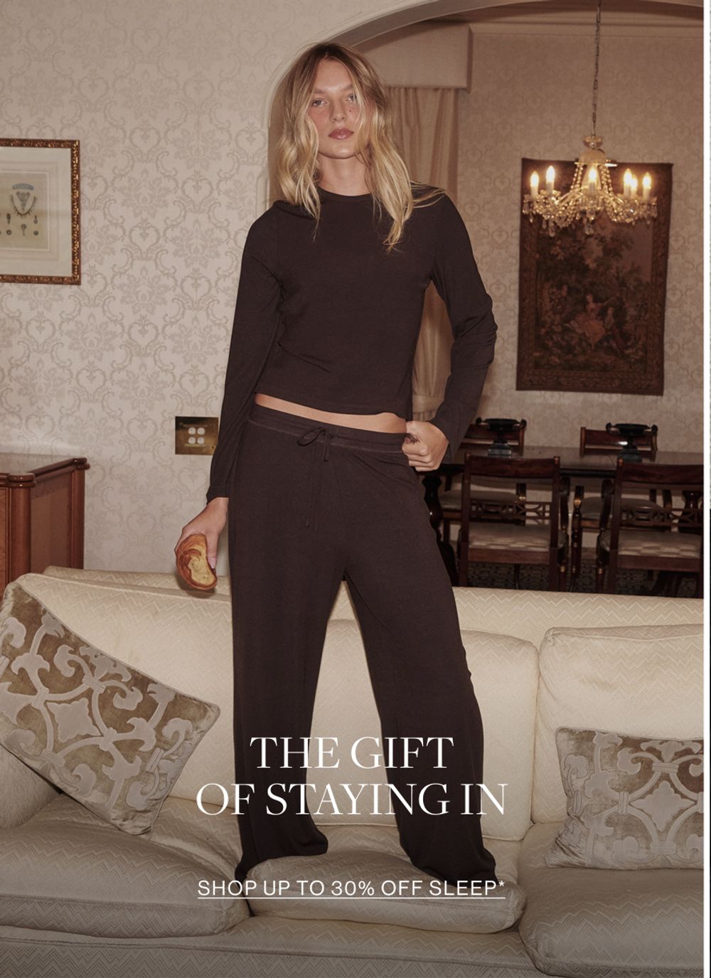Woman in chocolate sleep set. Text reads the gift of staying in