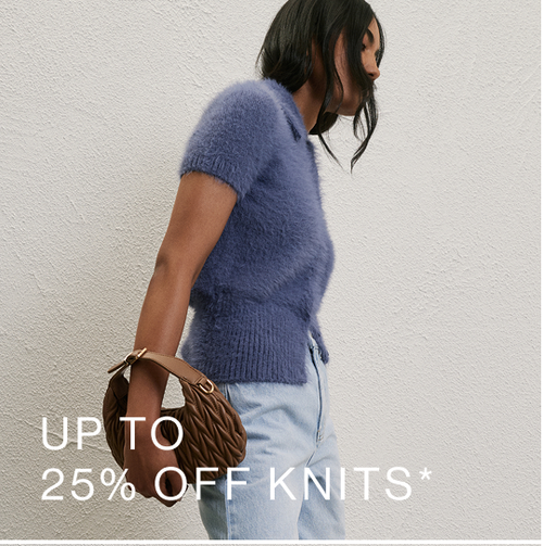 Model wearing a blue fluffy knit with light jeans and brown bag. SHOP 25% OFF KNITS.