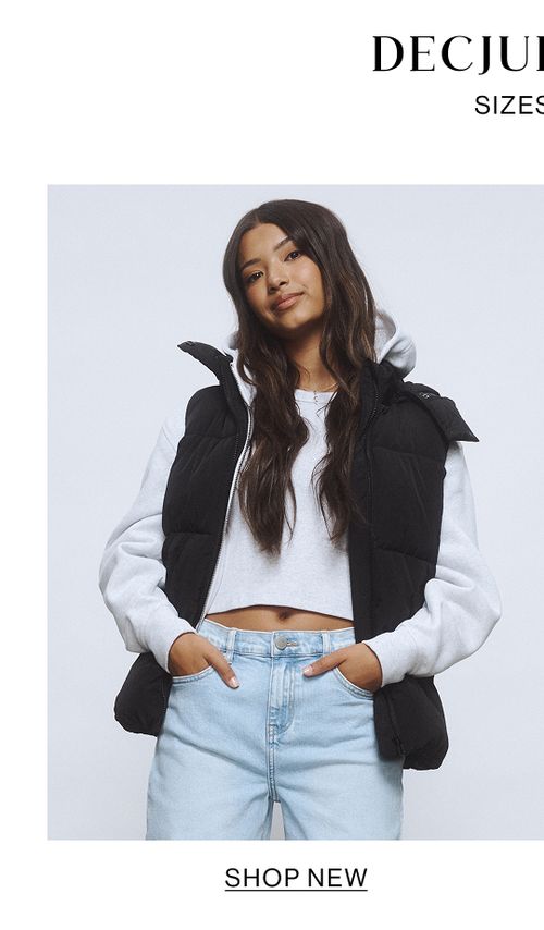 Young girl wearing a light blue denim jacket and skirt set.