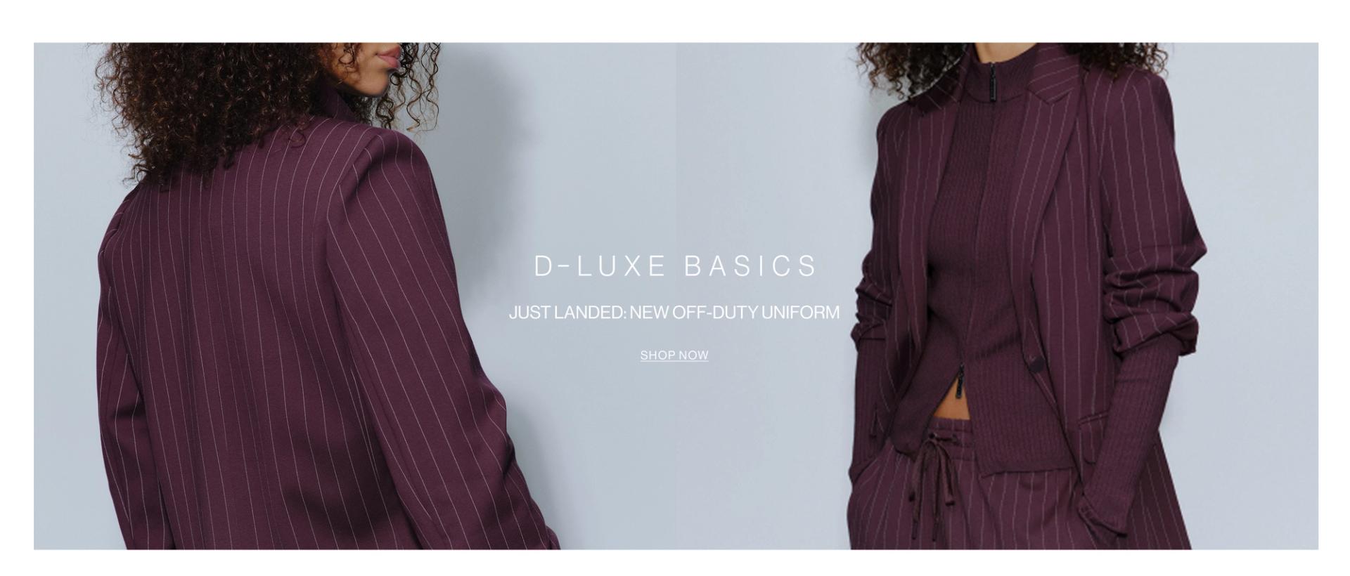 Model wearing a pinstripe blazer and pants in midnight cherry in a studio. SHOP NEW D-LUXE.