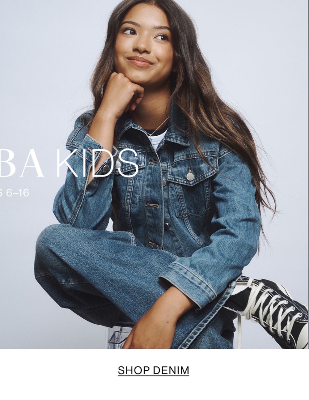 Young girl dressed in a white hoodie and matching sweatpants.