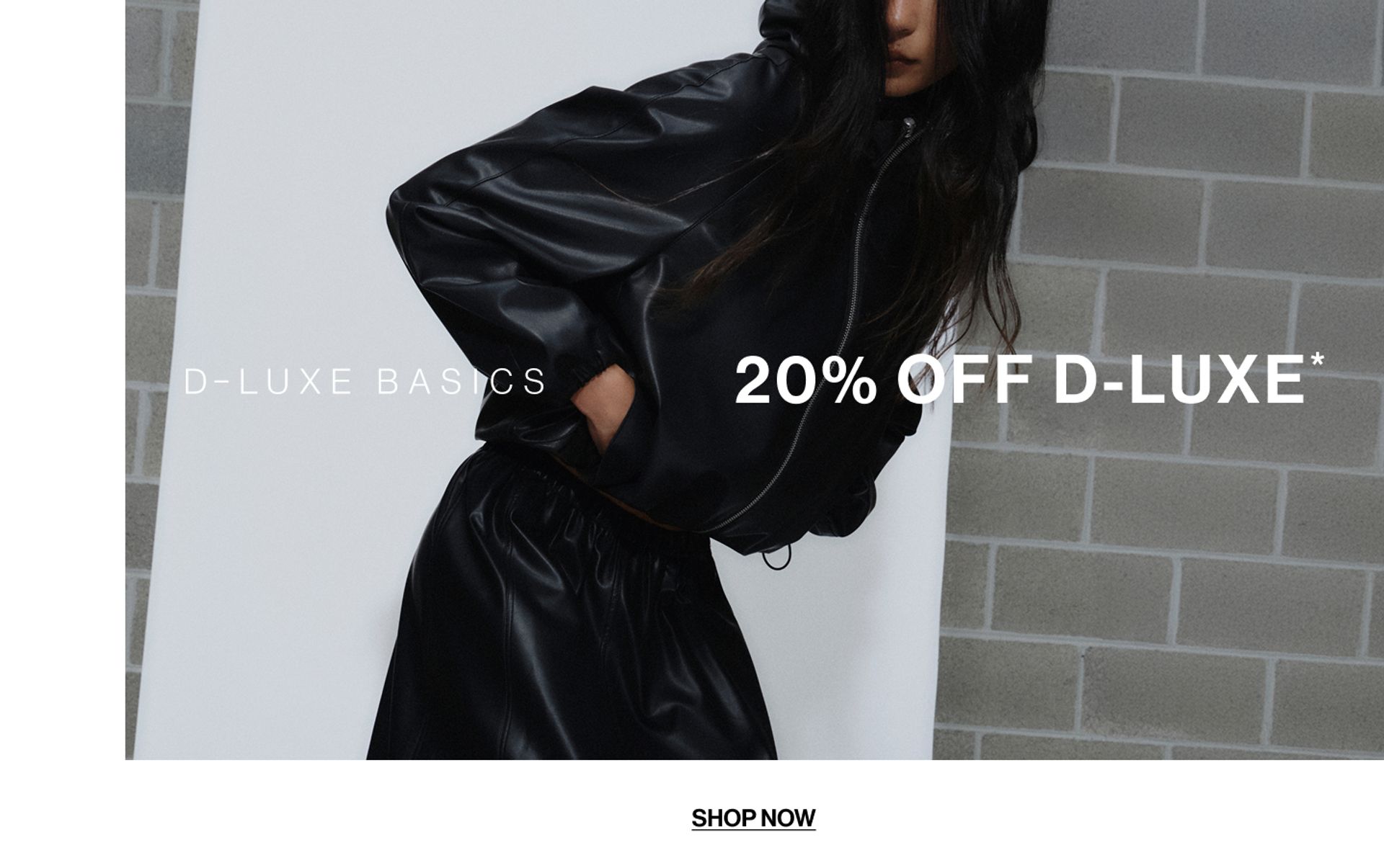 Model wearing a black bomber in a studio. Text reads 20% off D-Luxe.
