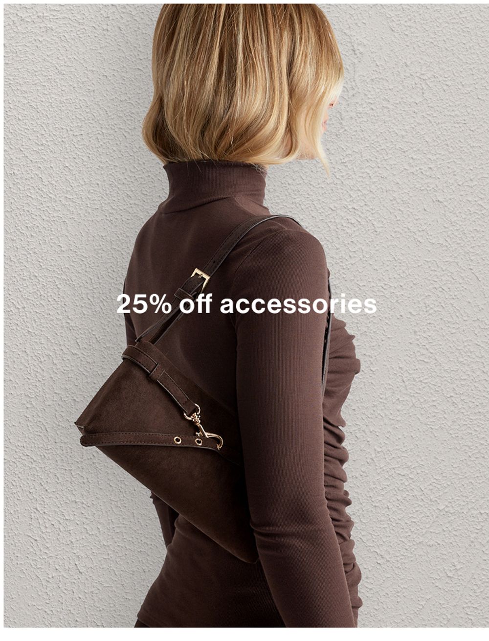 Model wearing a brown high neck long-sleeve top with a brown shoulder bag, promoting 25% off accessories