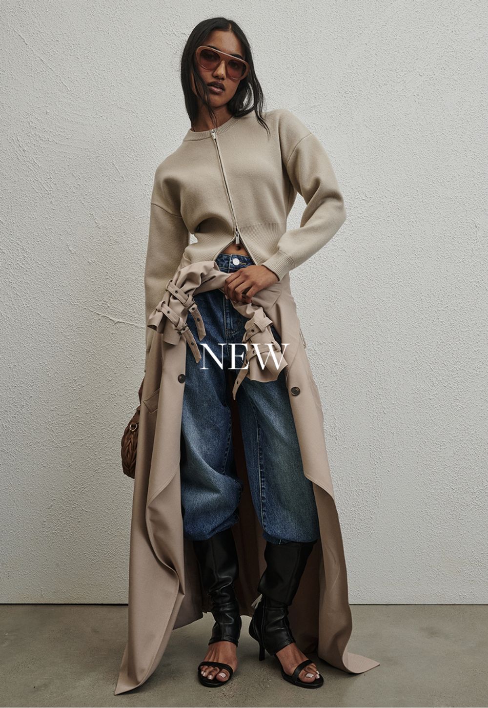 Model wearing a khaki trench. SHOP NEW.