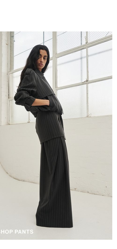 Model wearing a pinstripe set. SHOP PANTS