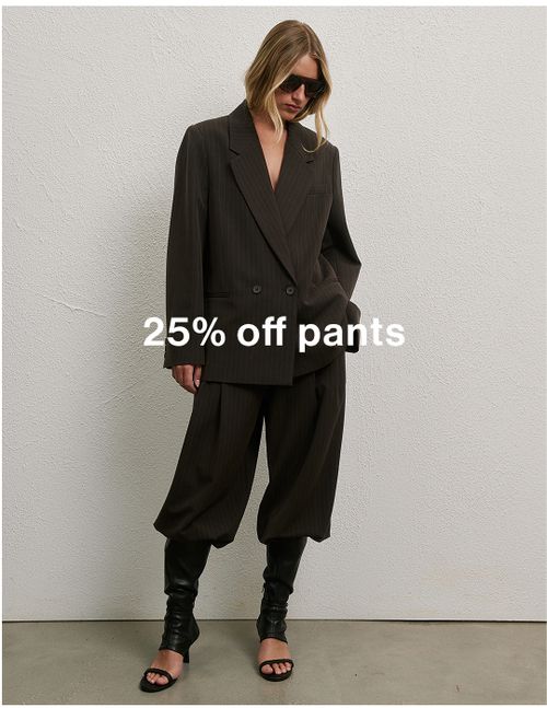 Woman in chocolate pinstripe set against a neutral background, promoting 25% off pants.