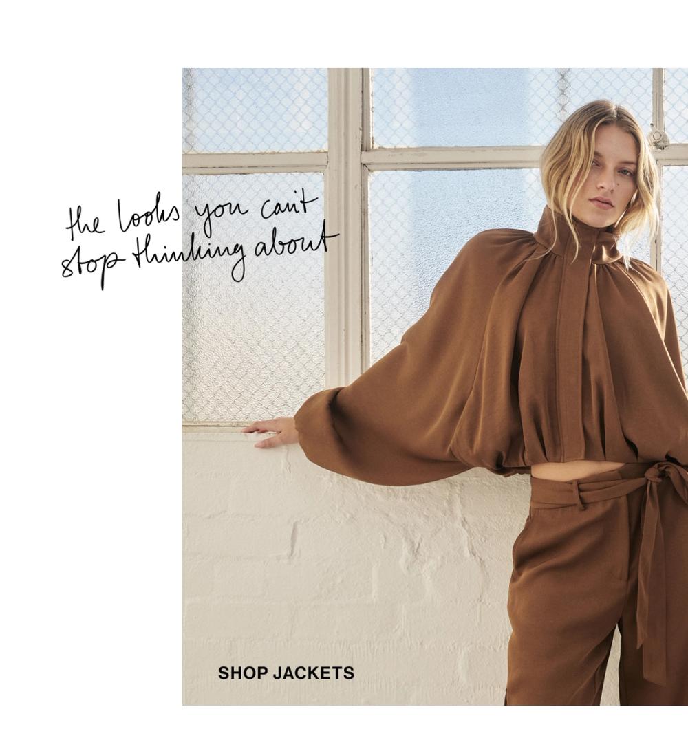 Model posing in a light brown bubble jacket. SHOP JACKETS.