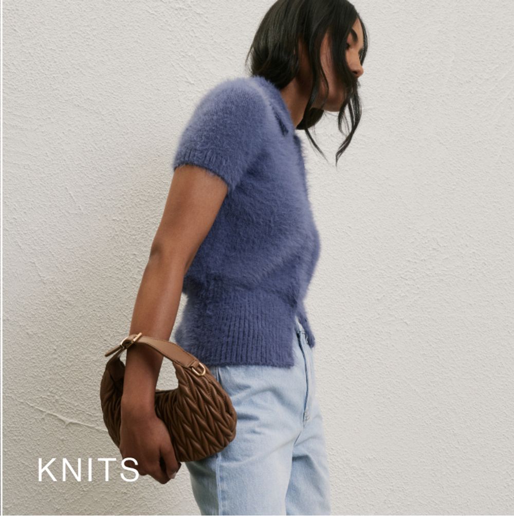 Model wearing a blue knit fluffy knit top. SHOP KNITS.