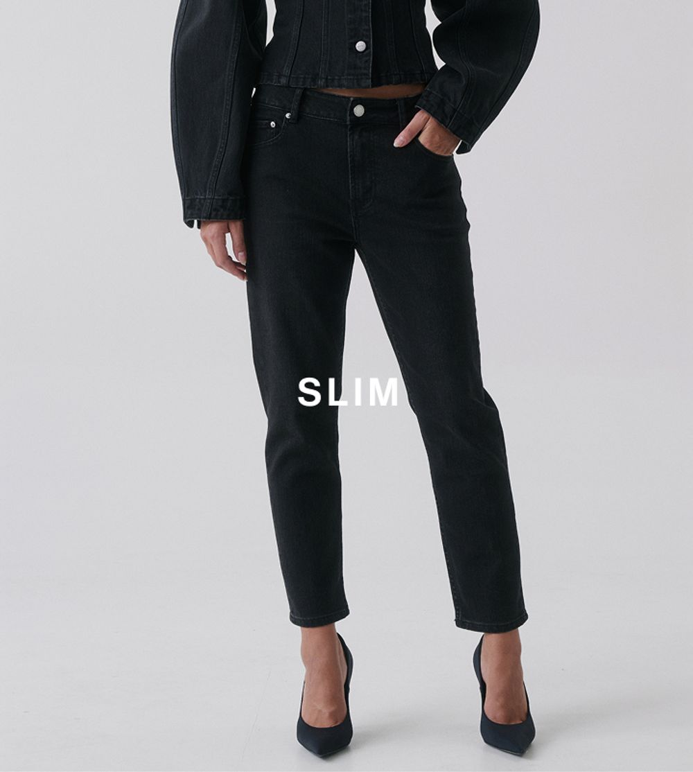 Model wearing slim black jeans and heels – Slim fit.