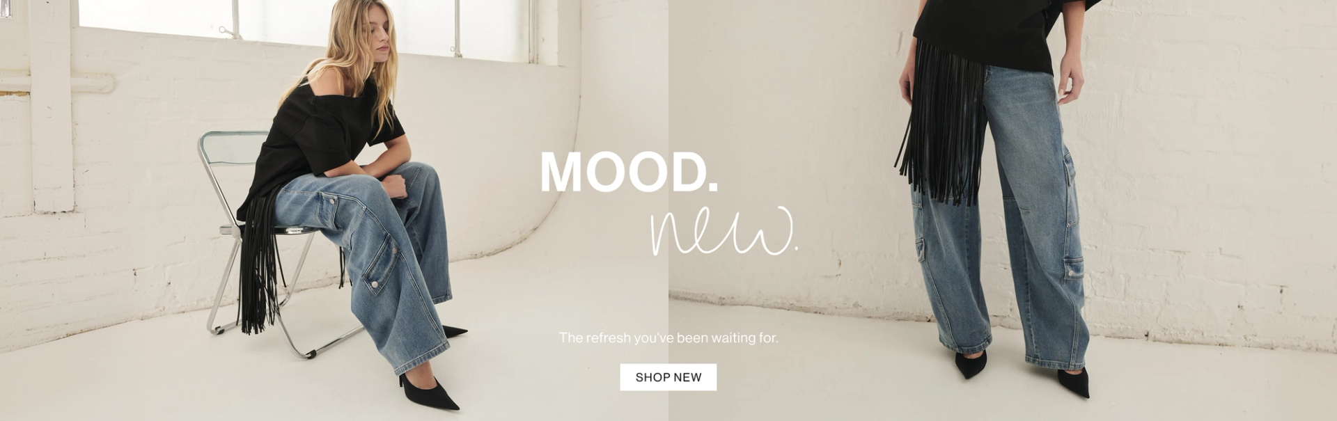 Model sitting in chair posing in off shoulder black tee and blue cargo jeans with text overlay: "MOOD. New."