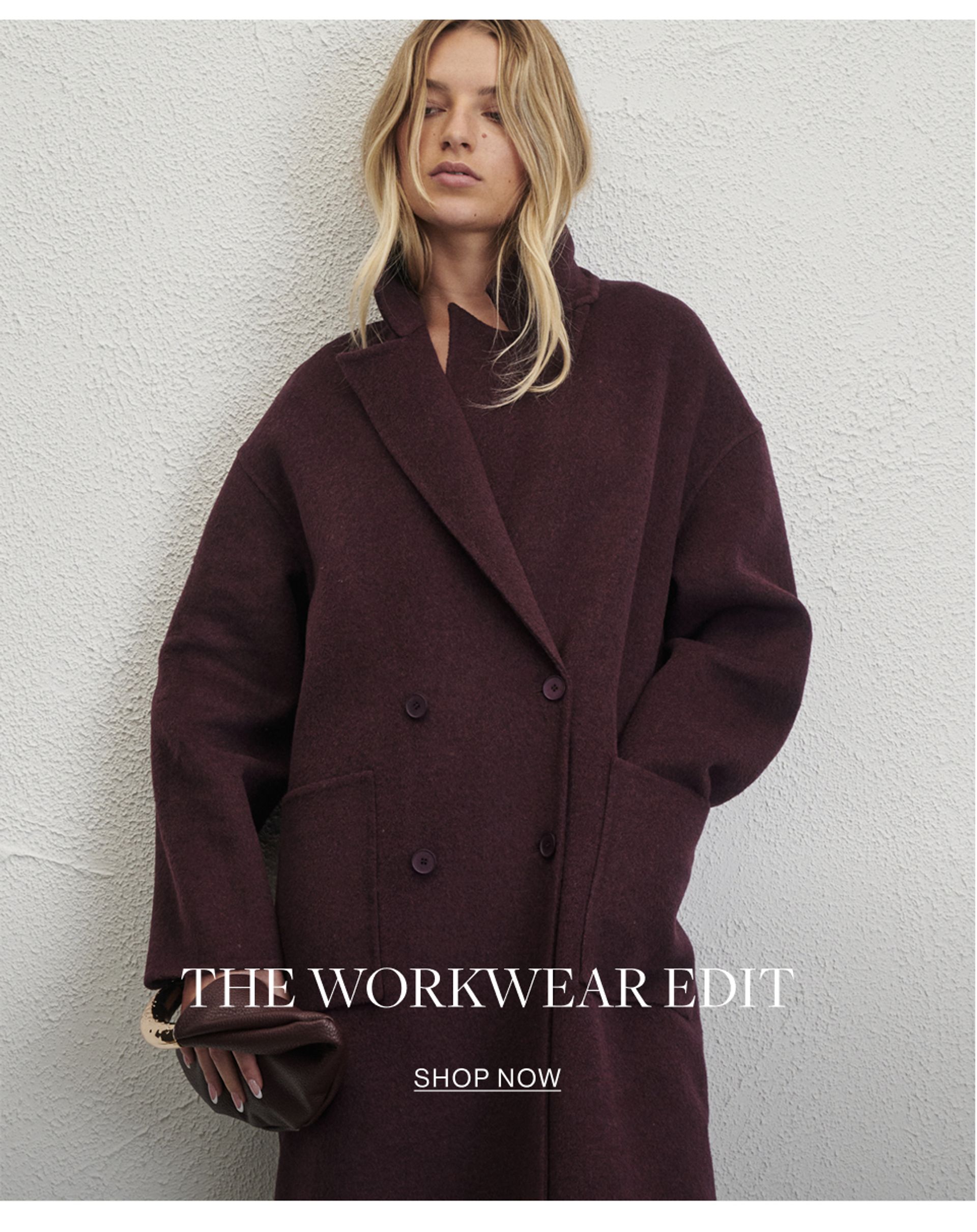 Model wearing a black high neck long sleeve mini dress. SHOP THE WORKWEAR EDIT.