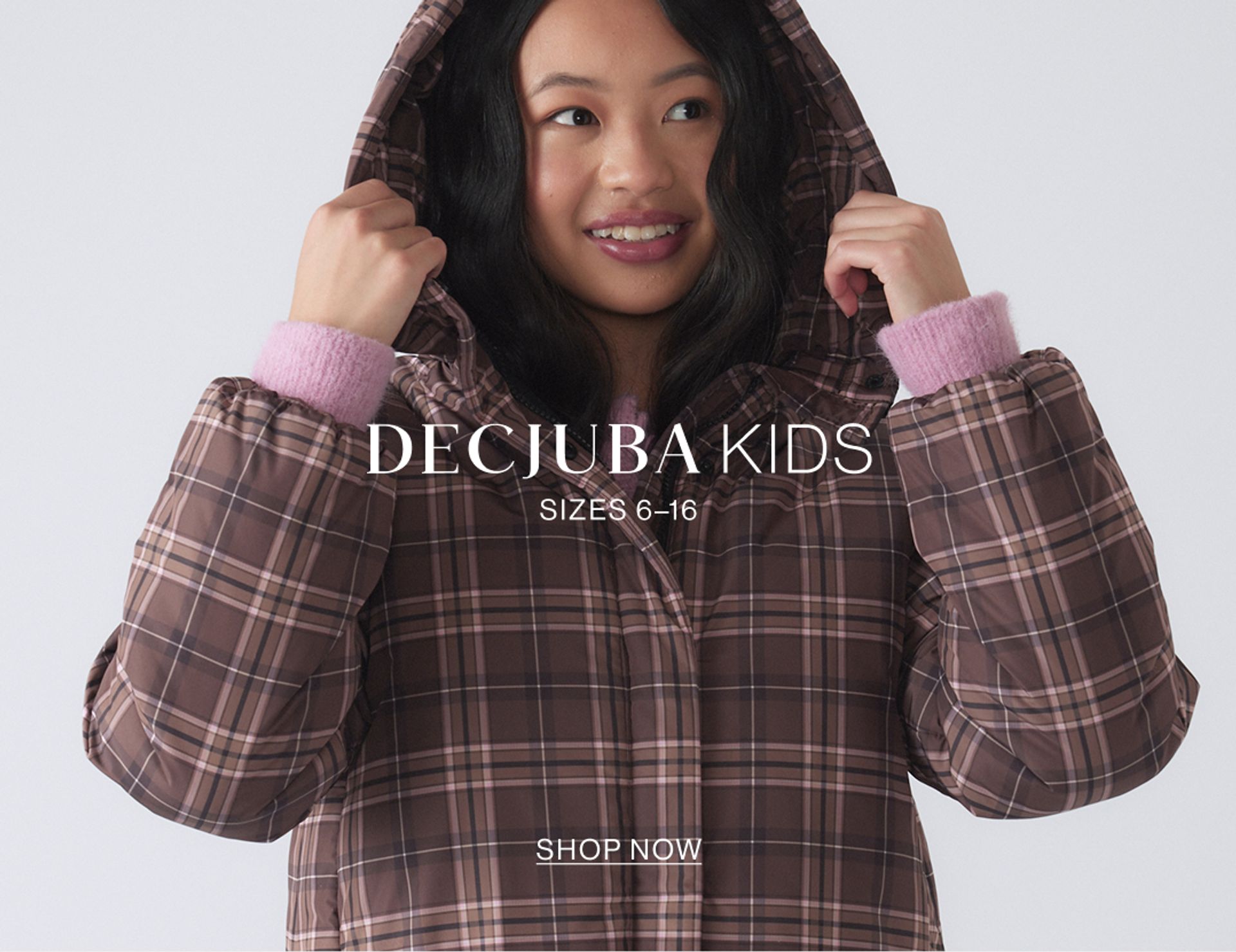 Image of young model wearing a gingham puffer jacket with text overlay: "DECJUBA KIDS SIZES 6-16"