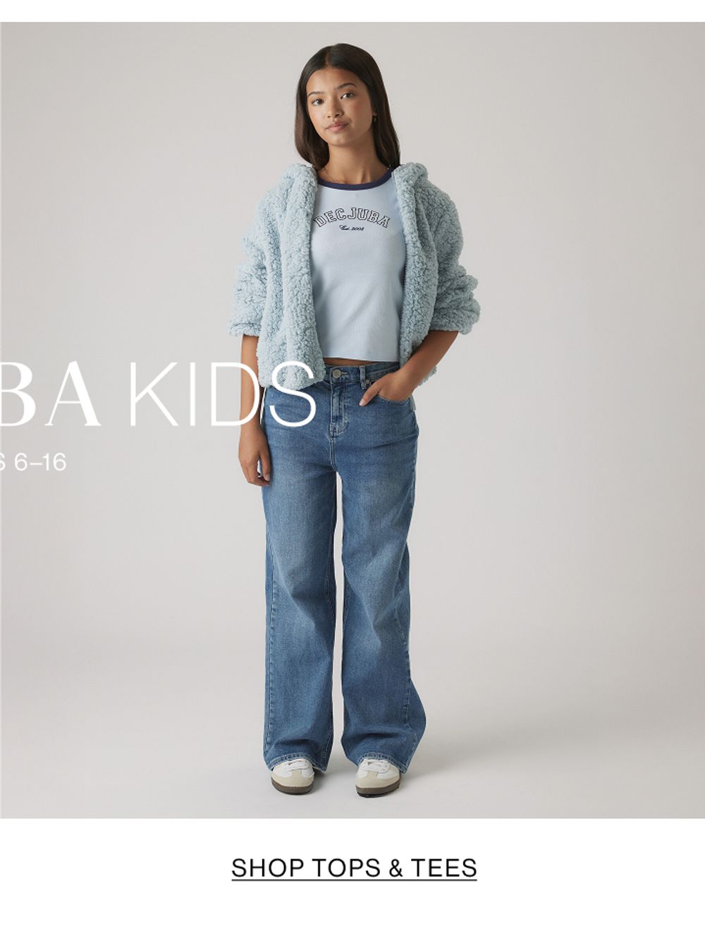 Girl in light blue top and wide-leg jeans – Kids Shop Tops & Tees.