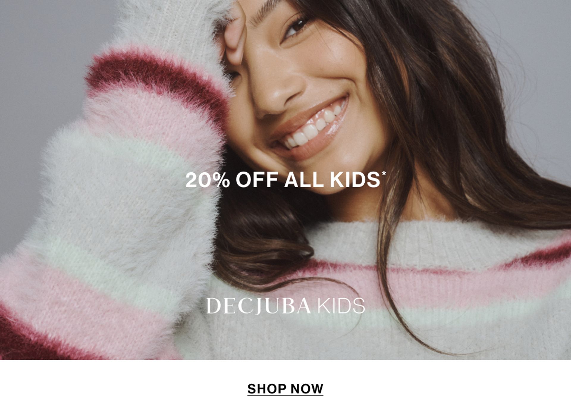 Model wearing a stripe knit in a studio. Text reads 20% off Kids.