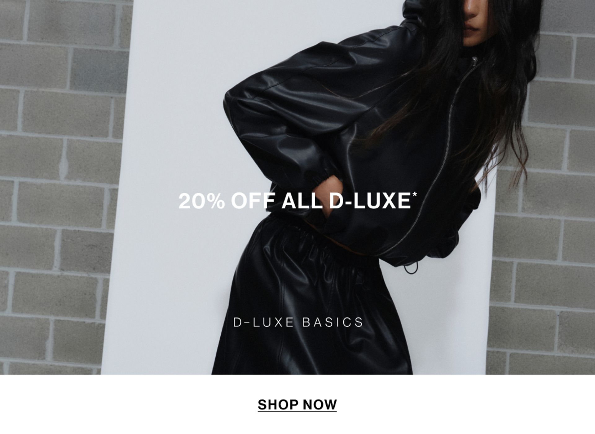 Model wearing a black bomber in a studio. Text reads 20% off D-Luxe.